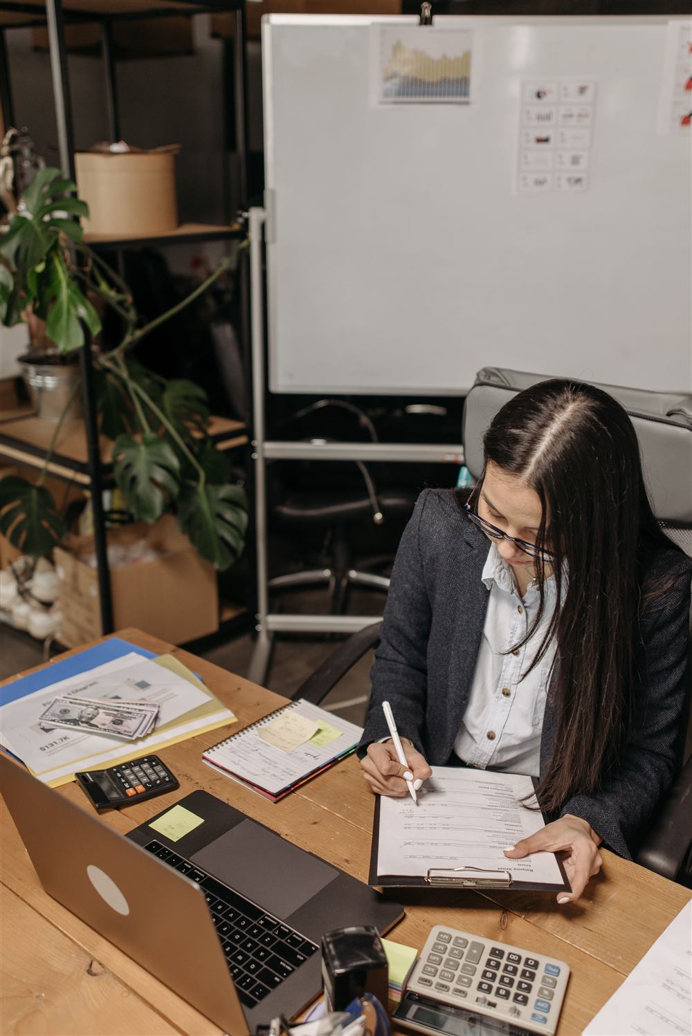 Chartered Professional Accountant preparing client files at her desk