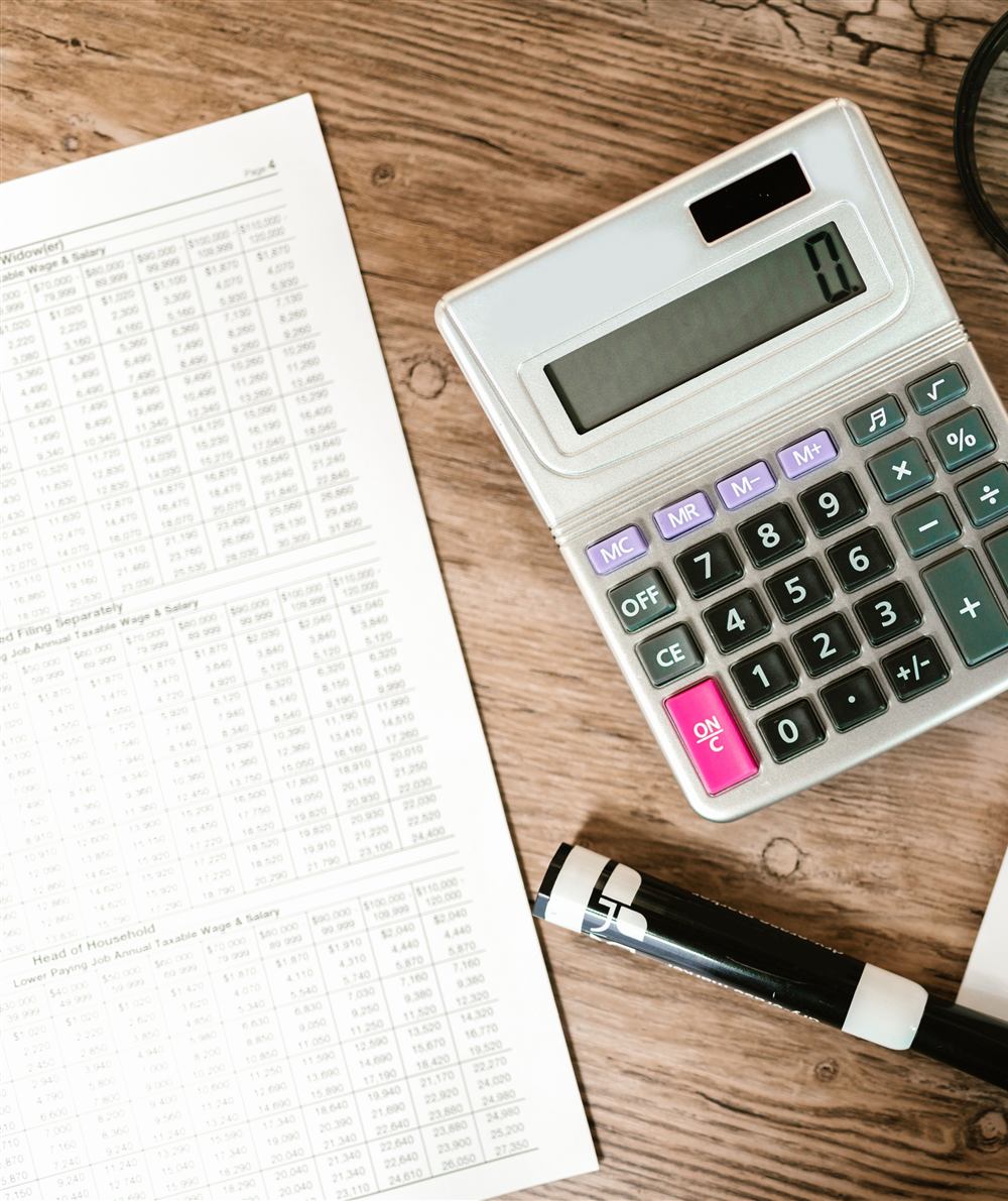 Personal tax return being reviewed line by line with a calculator